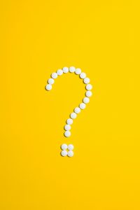 Question mark in pills representing What Hormones Cause Hair Loss?